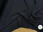 Tissu crêpe gaufré noir légèrement stretch au tombé plombant, effet double gaze