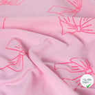JERSEY COTON 5% ELASTHANNE MOTIFS NOEUDS ROSES FOND ROSE - My Little Coupon
