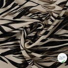 Sergé de viscose EcoVero feuilles pinceau sable - drapé