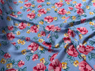 TISSU 100% VISCOSE IMPRIMÉ BRANCHES À FLEURS FOND BLEU CIEL - My Little Coupon
