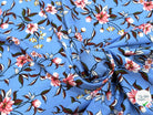 TISSU 100% VISCOSE IMPRIMÉ FOND BLEU CIEL - My Little Coupon