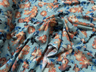 TISSU 100% VISCOSE IMPRIMÉ GROSSES BASES DE FLEURS FOND VERT D'EAU - My Little Coupon