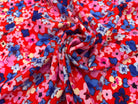 VISCOSE D'UNE MULTITUDE DE FLEURS FOND ROUGE MLC INTERN